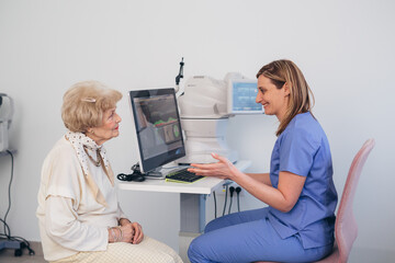 older woman has eye examination. digital retina scanner