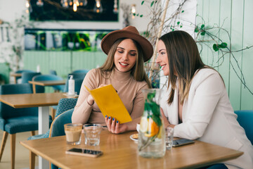 women looking menu in restaurant
