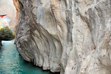 Canyon Saklikent in Turkish means "hidden city". Saklikent National Park in province of Mugla. Wild natural beauty. Emerald water of Yeshen River. Bottom of gorge. Fascinating canyon rocks.