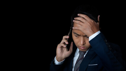 Portrait of businessman using smartphone feeling disappointed, unhappy gesture.