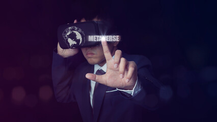 Man wearing VR Headset touching metaverse text on neon color background.