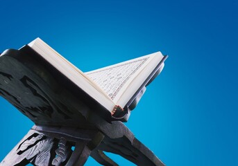 The holy book of the Koran on the woden stand