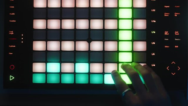 Hand of a sound engineer who is pressing keys on a parametric launchpad