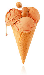 Ice cream with candies and dripping caramel isolated with clipping path.