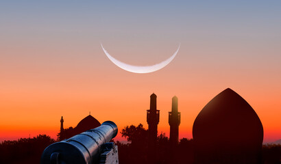 Ramadan Concept - Ramadan kareem cannon with crescent silhouette of mosque in the background  -...