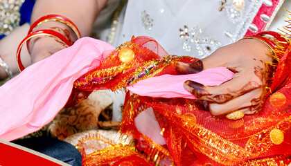 Indian bride and groom during Gath Bandhan ritual ceremony