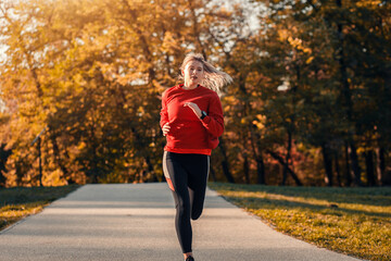 Fototapeta premium Young woman running in park.
