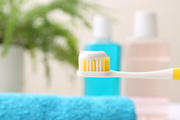 Fototapeta na wymiar Brush with toothpaste on blurred background, closeup