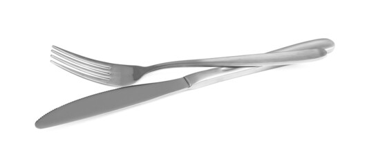 Shiny fork and knife on white background