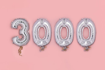 Balloon Bunting for celebration of 3000 made from Silver Number Balloons on pink background....