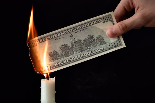 dollar inflation and world financial crisis concept, 100 dollars banknote burns in fire, depreciation of money