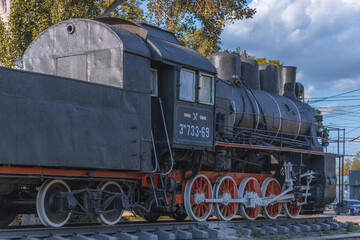 Old locomotive -Em-733-69. Monument at the railway station in the city of Krivoy Rog in Ukraine. summer sunny day