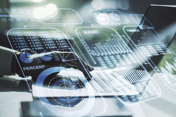 Double exposure of abstract creative statistics data hologram with hands typing on laptop on background, statistics and analytics concept