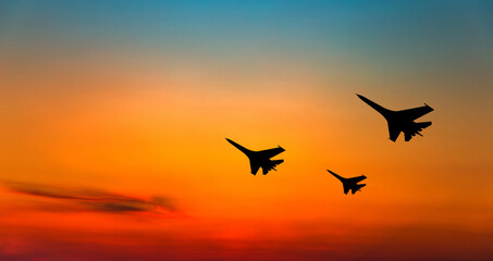 War aircrafts at sunset sky.
