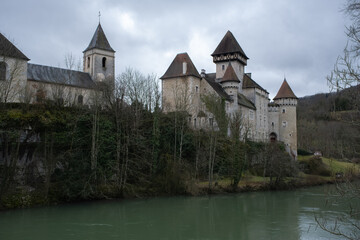 Obraz premium Scey-Maisieres, France - February 20 , 2022: The castle of Cleron is a 14th-century castle on the river Loue in the Bourgogne-Franche-Comte. Cloudy winter day. Selective focus.