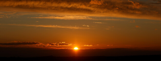 panoramic sunset with sun and clouds