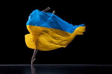 Hope. Young graceful classic ballerina dancing with cloth painted in blue and yellow colors of...