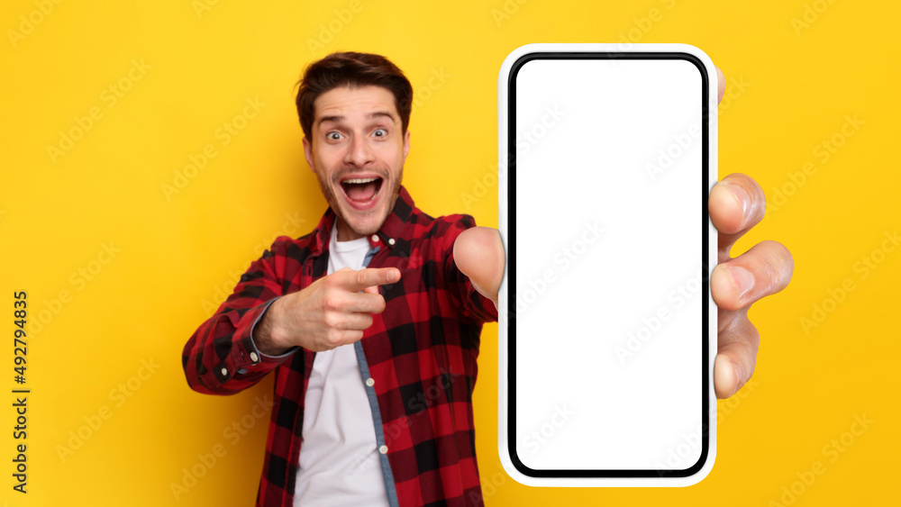 Poster shocked guy pointing at white empty smart phone screen