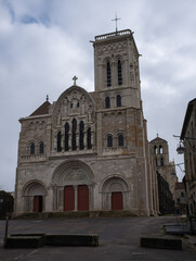 Fototapeta na wymiar Vezelay, France - February 23 , 2022: Vezelay Abbey is a Benedictine and Cluniac monastery in the Bourgogne-Franche-Comte. Cloudy winter day. Selective focus.