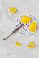 Retro plate with lemons on vintage white background and vintage knife