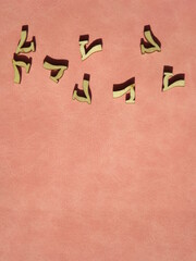 wooden number 7 on pink suede in an arbitrary arrangement