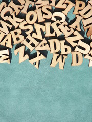 Wooden letters of the alphabet on a blue background with space for text