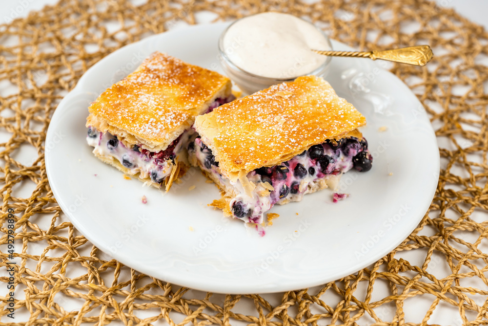 Wall mural 2 piece of dessert from puff pastry with blueberry and cream.