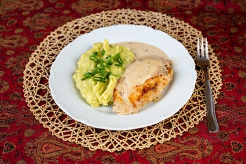Fried chicken pocket, rosemary sauce and mashed potato with pea.