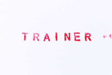 Red color ink rubber stamp in word trainer on white paper background