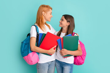 smiling school pupil and student holding textbooks and backpack, study