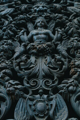 Fototapeta na wymiar PARIS, FRANCE, 08.03.2022 Forged iron angels, Indian motifs on the door.