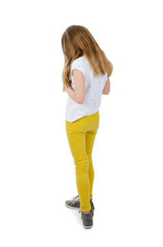 Rear view of modern little girl, standing. Isolated on white background. Back view