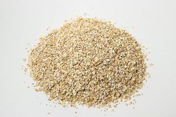 Dry oatmeal on a white background. Healthy and tasty food. Food for weight loss