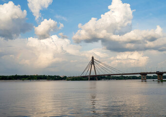 Kyiv landscape: Reflection of the bridge and clouds in the Dnieper river (Dnipro)
