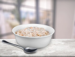 Tasty breakfast Oatmeal porridge in white bowl