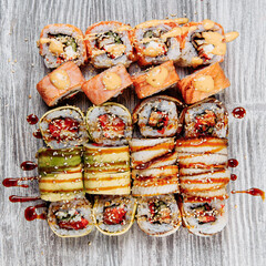 Cold cooked rice dressed with vinegar that is shaped into pieces and topped with raw or cooked fish, or formed into a roll with fish, egg, or vegetables and often wrapped in seaweed.