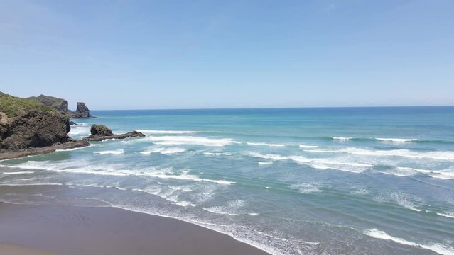 Turquoise Ocean And Foamy Waves At Bethells Beach, Auckland, North Island, New Zealand - aerial drone shot