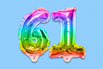 Rainbow foil balloon number, digit sixty one on a blue background. Birthday greeting card with...