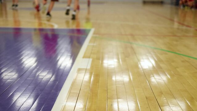 View of basketball court hall indoor venue with junior teenage school team playing in the background, basketball match game on arena stadium, team is blurred with copy space