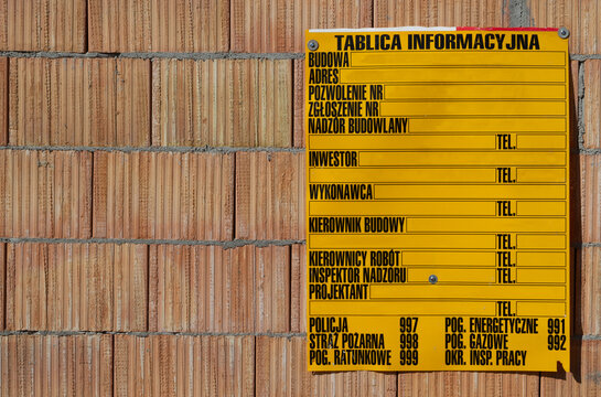 Yellow Information Board In Polish Language, On The Construction Site. With Info About Supervision Authority, Investor And Contractor, Address And Type Of Works, Date And Number Of Permit.