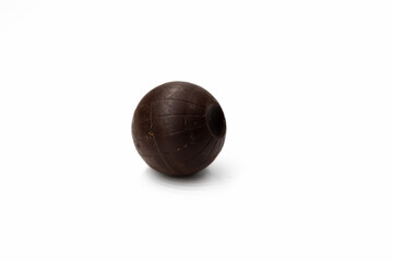 One round brown chocolate candy with a design like Death Star of Star Wars on a white background...