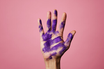 hand of a man with stains of purple paint