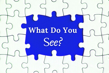 Fototapeta premium Text on missing jigsaw puzzle - What do you see. With blue background.