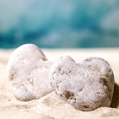 Fototapeta na wymiar Summer sand sea beach with waves and heart stones