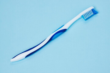 Blue toothbrush on a blue background with copy space