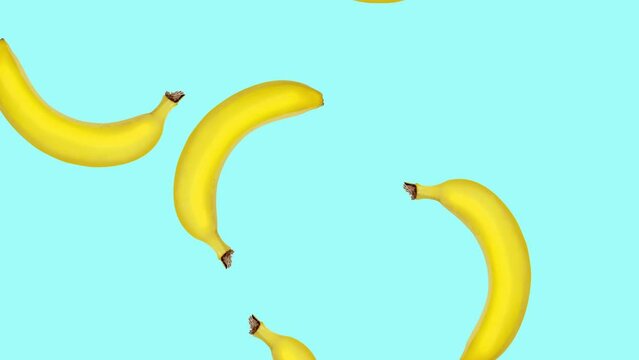 Abstract colorful animation - bananas falling and rotating at color background. Seamless loop animation.