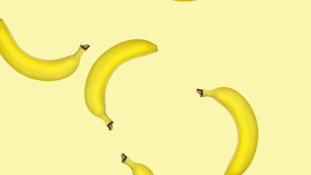 Abstract colorful animation - bananas falling and rotating at color background. Seamless loop animation.