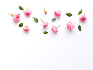 Styled stock photo. Spring feminine scene, floral composition. Decorative banner, corner made of beautiful pink roses. White table background. Flat lay, top view.