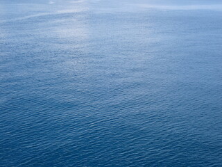 The surface of a calm blue sea without waves.