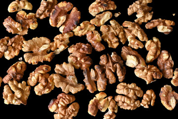walnut seeds, isolated nuts, top view, black background